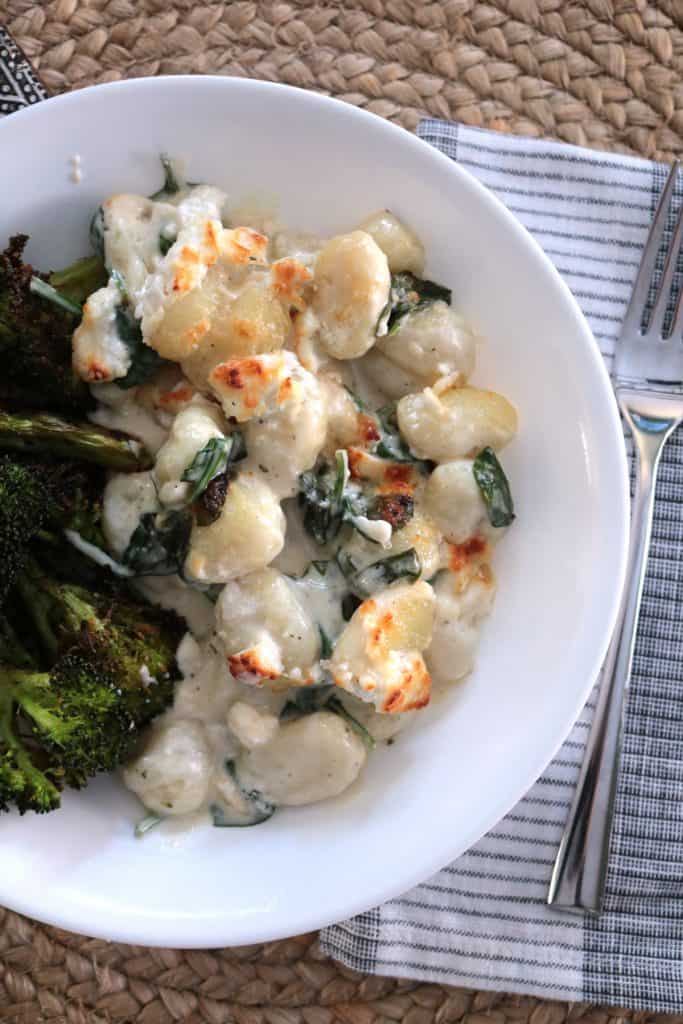 Gnocchi with Goat Cheese and Spinach in a Bowl with Roasted Broccoli.