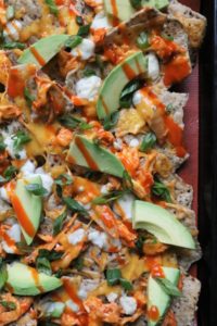 Sheet pan of baked buffalo chicken nachos