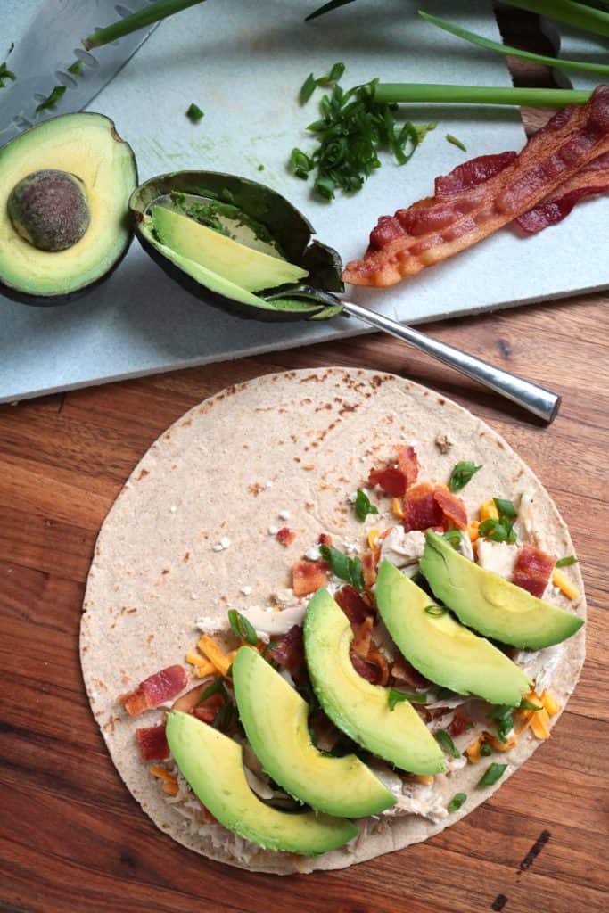 Assembling Cheesy Chicken, Bacon & Avocado Quesadillas.