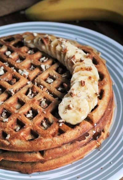 Banana Pecan Waffles topped with more banana slices and pecans