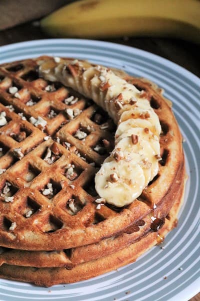 Banana Pecan Waffles topped with more banana slices and pecans