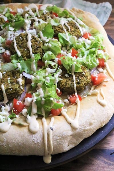 Pizza topped with falafel