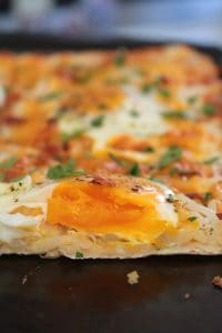 Breakfast Pizza topped with Eggs.
