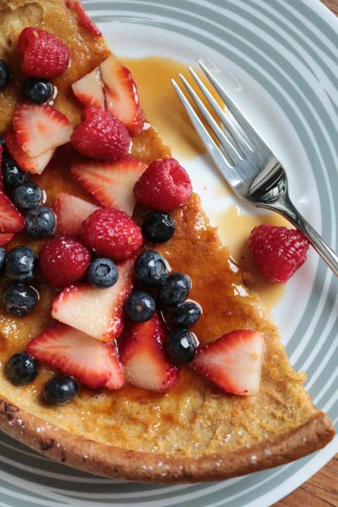 Dutch Baby German Pancakes with Syrup and Berries.