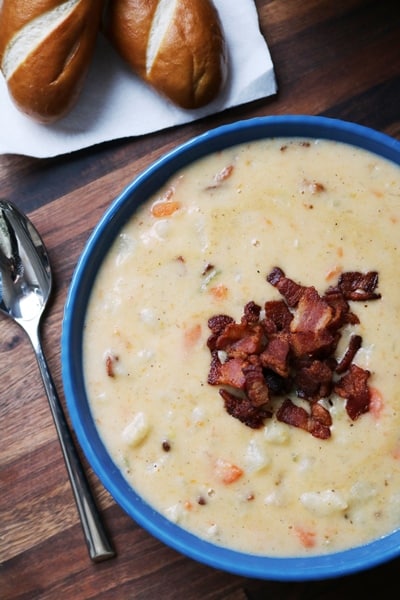 Cheddar Baked Potato Soup served with pretzel rolls.