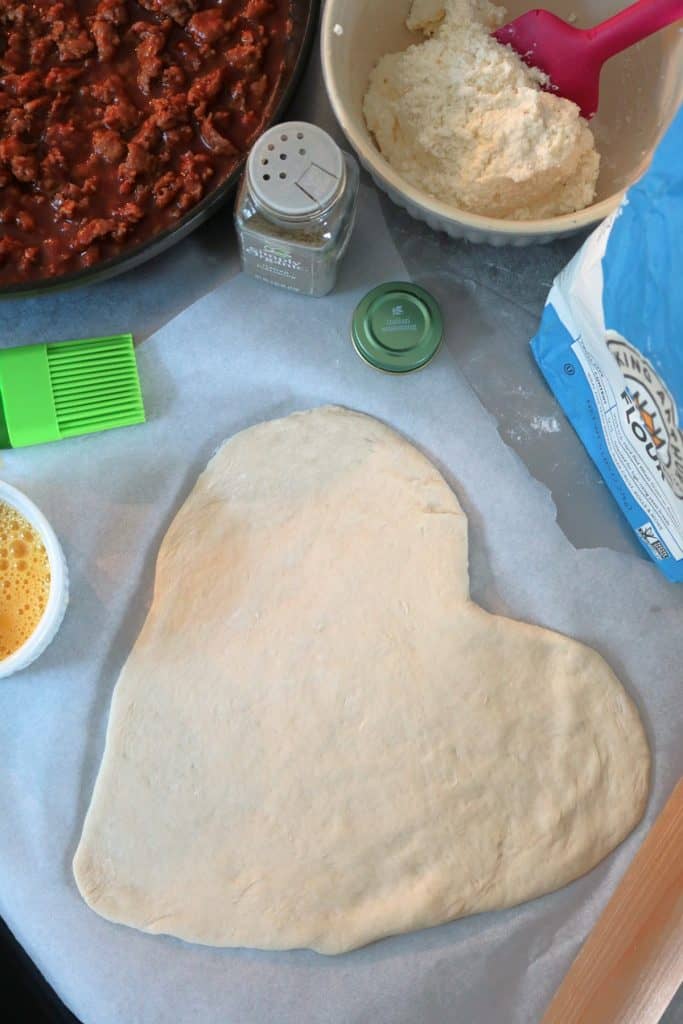 Assembling a Sausage Lasagna Heart Calzone.