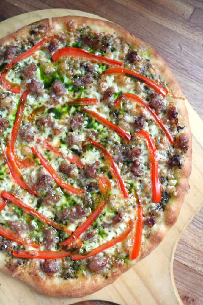 Sausage, Red Bell Pepper, and Spinach Pesto Pizza.
