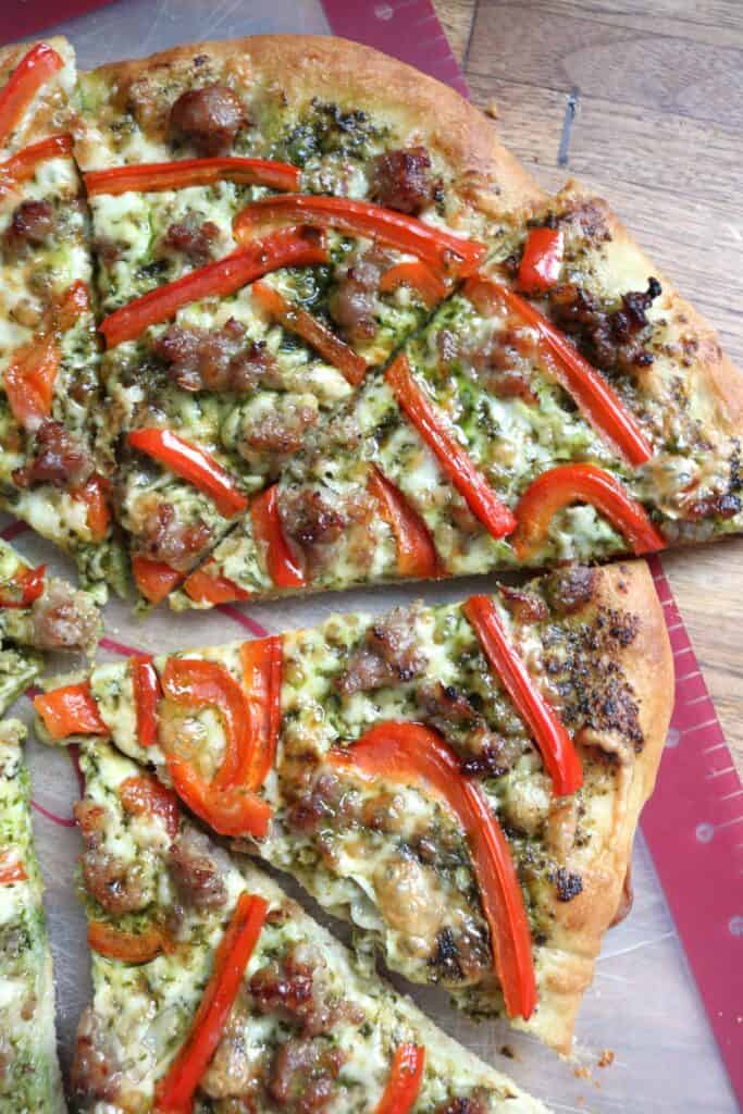 Sliced Sausage, Red Bell Pepper, and Spinach Pesto Pizza.
