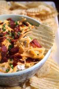 Loaded Baked Potato Dip with wavy potato chips.