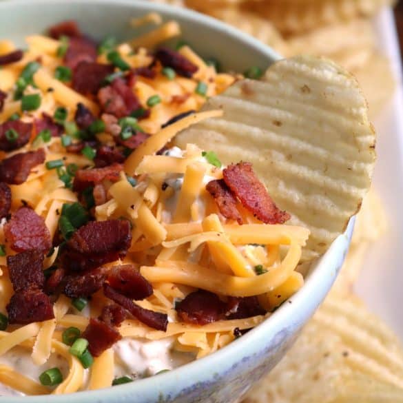 Loaded Baked Potato Dip with wavy potato chips.