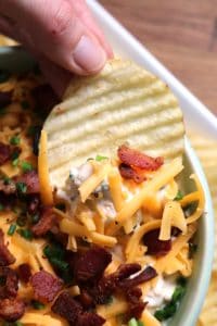 Chip dipped into Loaded Baked Potato Dip.