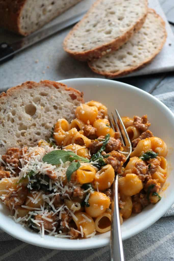 Bowl of Pasta with Butternut Sauce, Spicy Sausage and Baby Spinach.