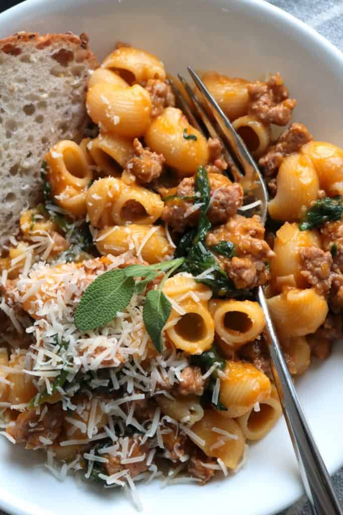Garnished Pasta with Butternut Sauce, Spicy Sausage and Baby Spinach.