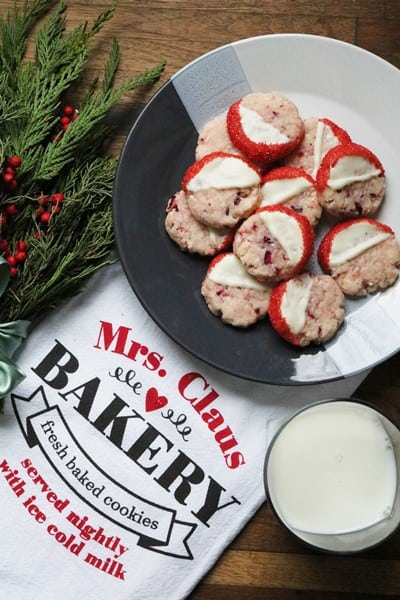 White Chocolate Cranberry Shortbread Cookies on a plate with milk
