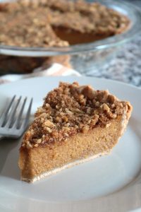 Slice of Pumpkin Pie with Brown Sugar-Walnut Topping.
