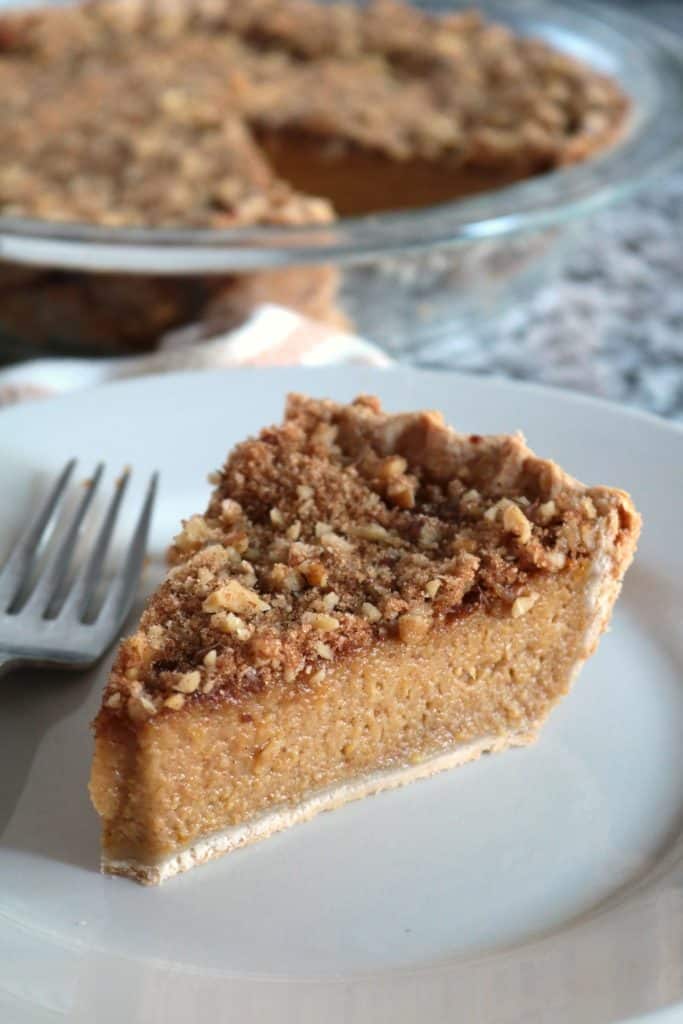 Slice of Pumpkin Pie with Brown Sugar-Walnut Topping.