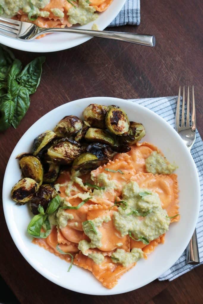 Sun-Dried Tomato Ravioli with Basil Cream Sauce and Brussels Sprouts.