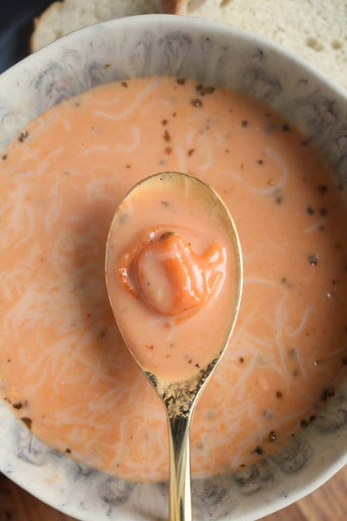 Spoon with Creamy Tomato Tortellini Soup.