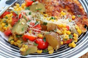 Baby Potatoes with Tomato Corn Saute served with Grilled Chicken.