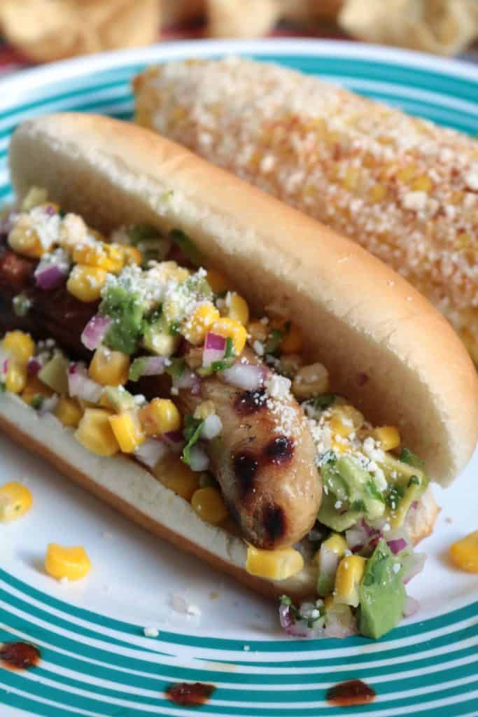 Mexican Hot Dogs with Corn Salsa and Chipotle Cream.