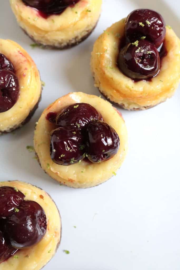 Mini Lime Greek Yogurt Cheesecakes topped with Cherries.