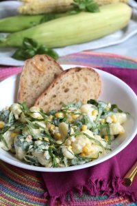 Gnocchi, Sweet Corn & Arugula in Cream Sauce topped with Fresh Basil.