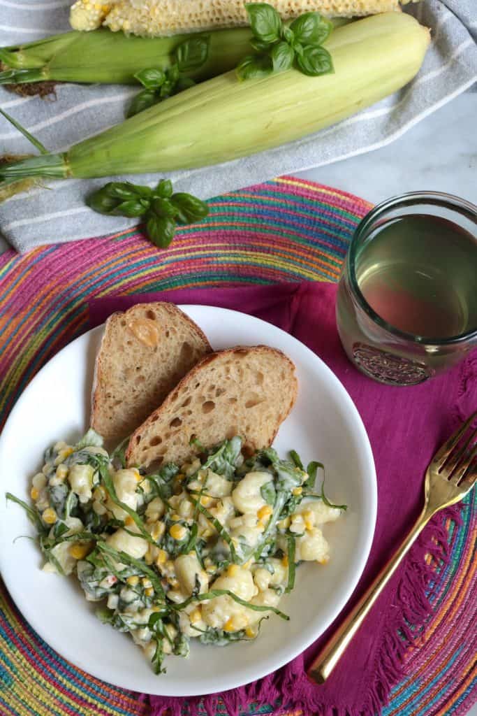Gnocchi, Sweet Corn & Arugula in Cream Sauce with Glass of White Wine.