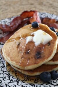 Blueberry-Flax Buttermilk Pancakes with butter and syrup.