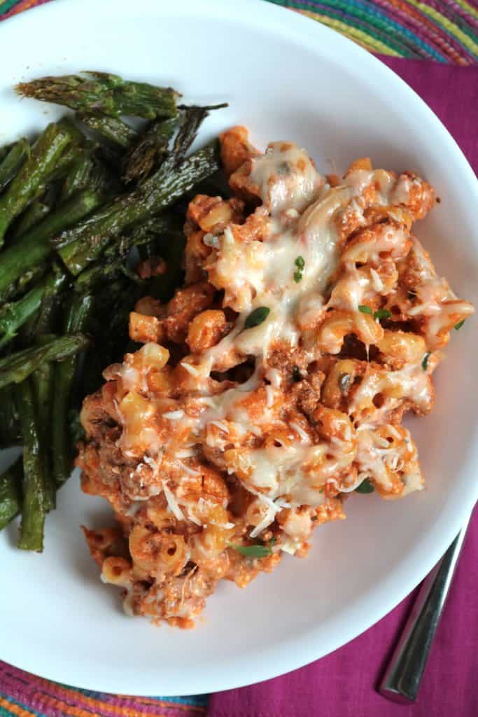 Skillet Lasagna on a plate with Roasted Asparagus.