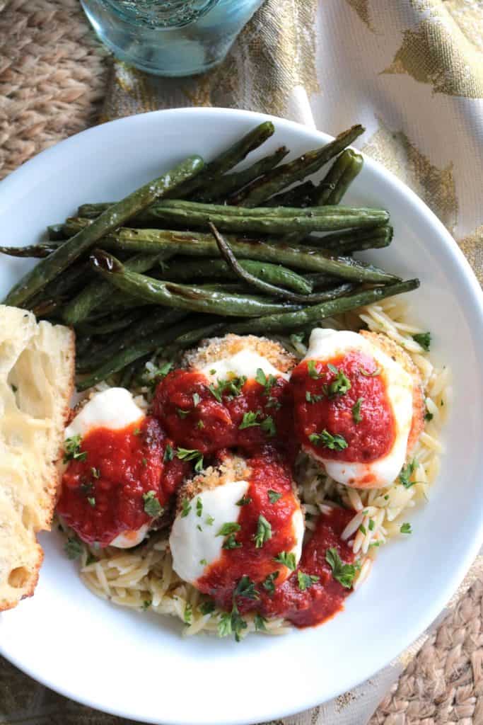 Oven-Fried Eggplant Parmesan with Parsley Orzo, Roasted Green Beans, and Focaccia. 