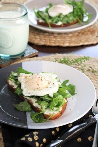 Ricotta Toast with Arugula and Egg on a plate.