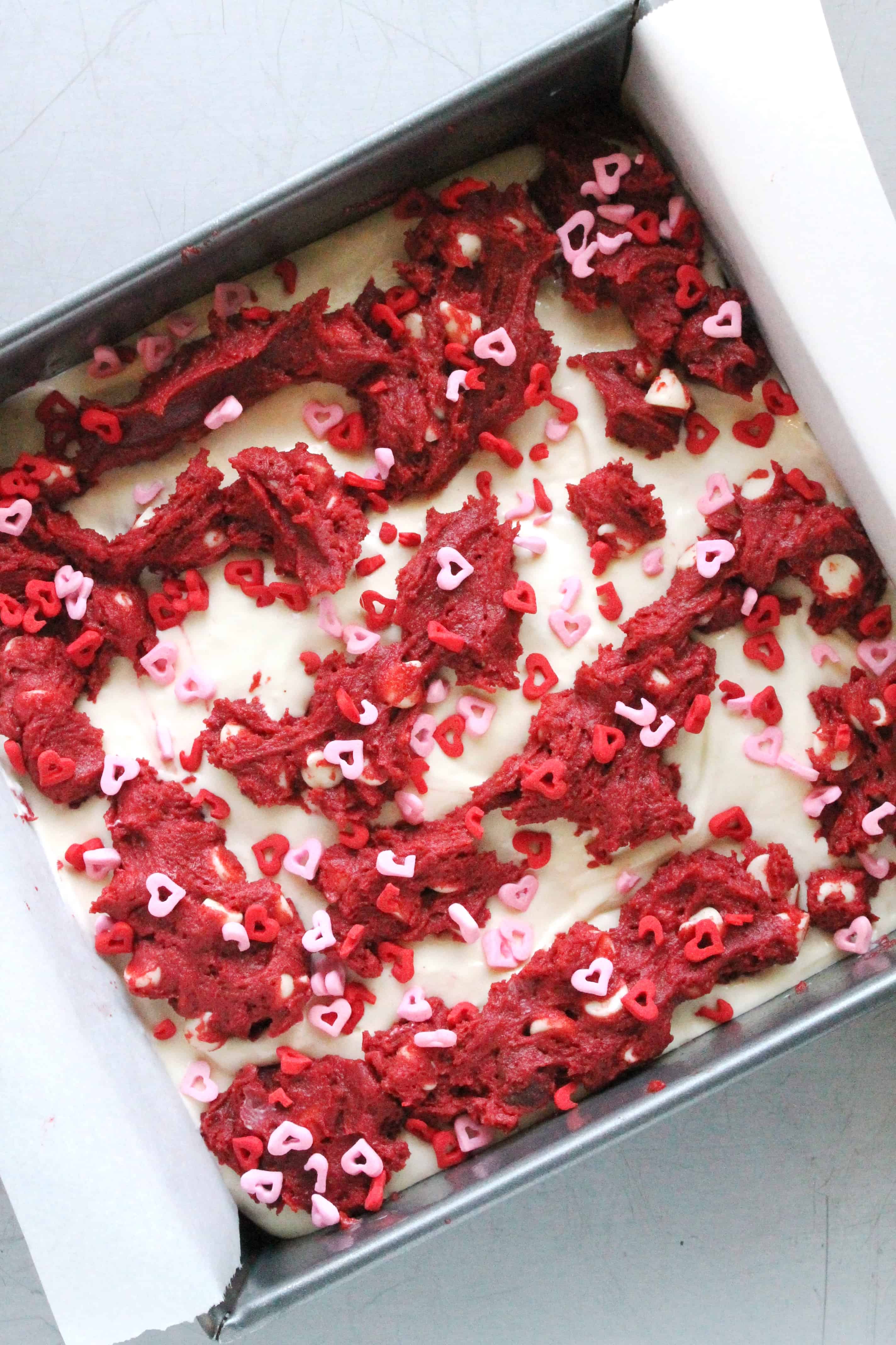 Red Velvet White Chocolate Chip Cookie Cheesecake Bars
