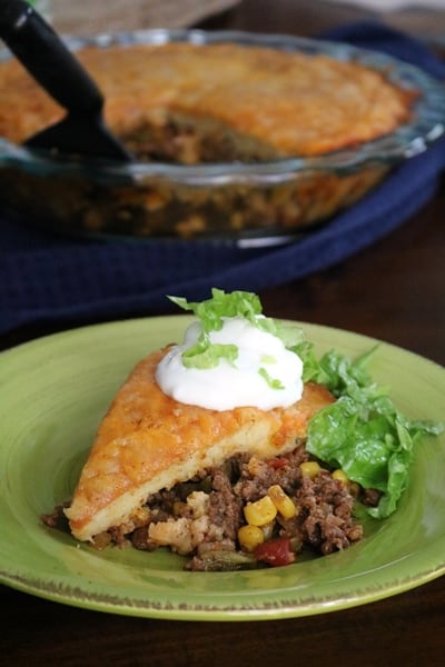 Impossible Texas Tamale Pie, topped with sour cream and lettuce.