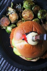 Vegan Spicy Chicken Sandwich made with Seitan and a side of Brussels