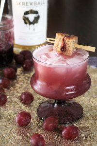Peanut Butter & Jelly Whiskey Sour with Mini Sandwich Garnish.