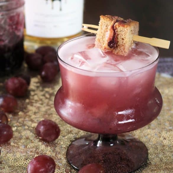 Peanut Butter & Jelly Whiskey Sour with Mini Sandwich Garnish.