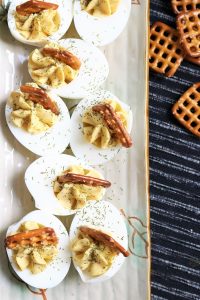 Honey Mustard Deviled Eggs topped with Pretzels.