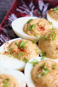 Sriracha Deviled Eggs, focused on the rear egg.