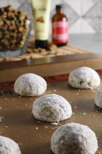 Bake Rosewater Pistachio Snowball Cookies.