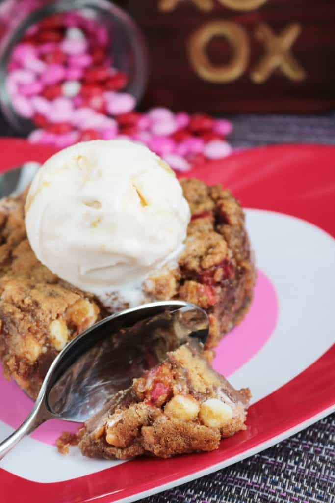 Heart-Shaped Reese's Stuffed Cookie with a spoon cutting into it.