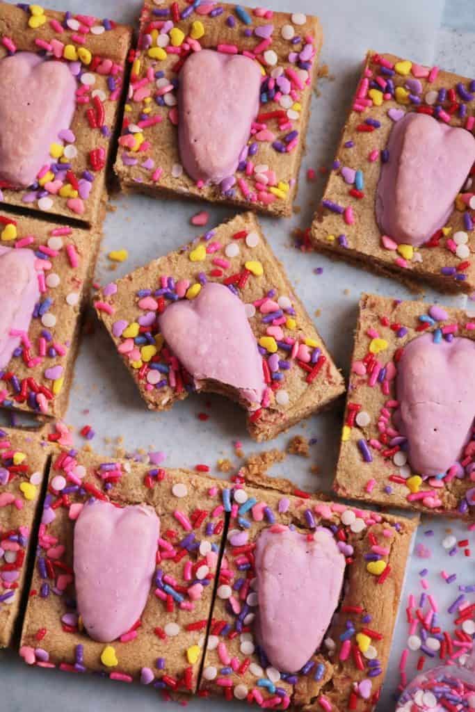 Over-head shot of Reese's Heart Peanut Butter Cup Cookie Bars with a Bite out of one.