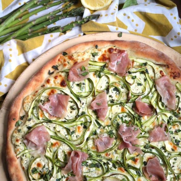 Shaved Asparagus Ricotta Pizza with Prosciutto on top.