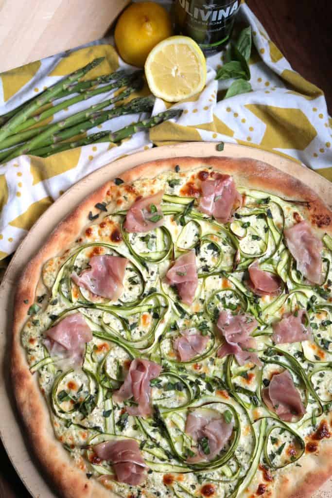 Shaved Asparagus Ricotta Pizza with Prosciutto on top.