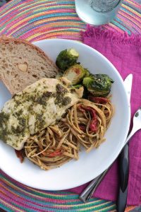 Arugula Pesto Pasta with pesto chicken, Brussels, and garlic bread.