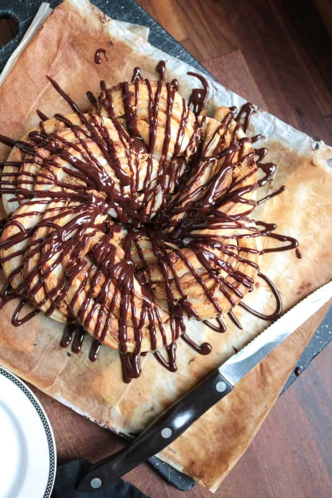 Peanut Butter Puff Pastry Ring topped with Chocolate Drizzle.