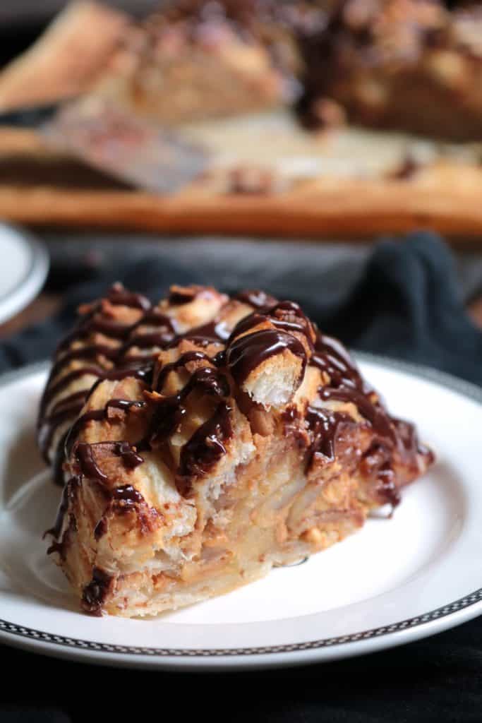Slice of Peanut Butter Puff Pastry Ring with Chocolate Drizzle.