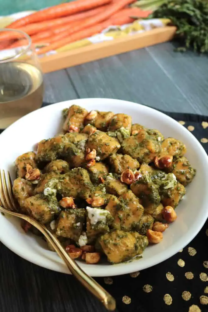 Carrot Gnocchi with Candied Hazelnuts and Carrot Top Pesto.