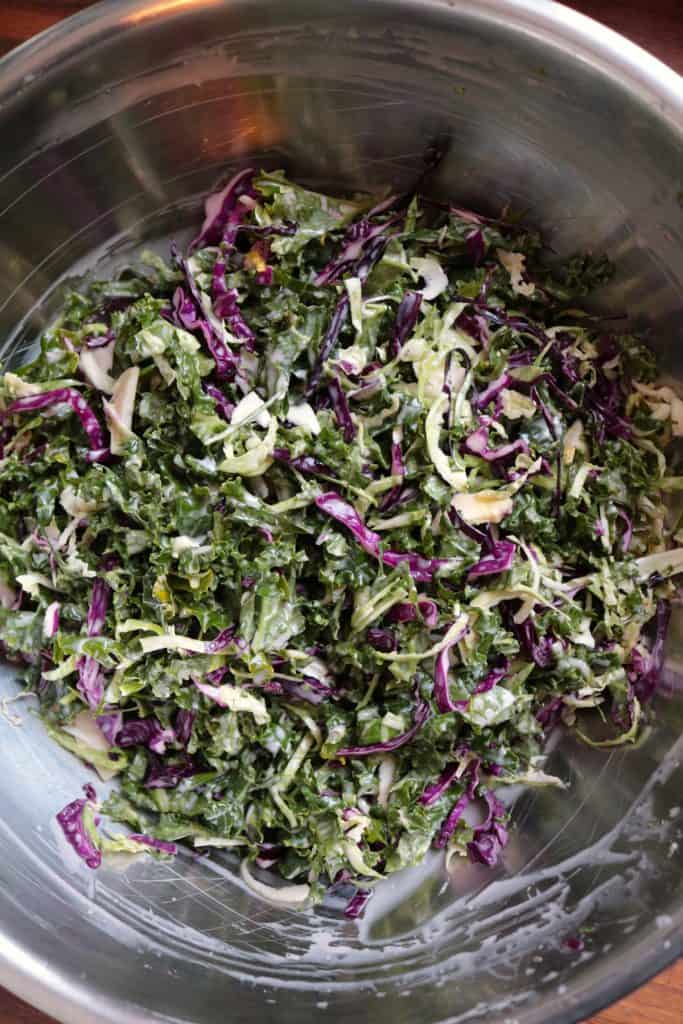 Kale Slaw tossed in a bowl.
