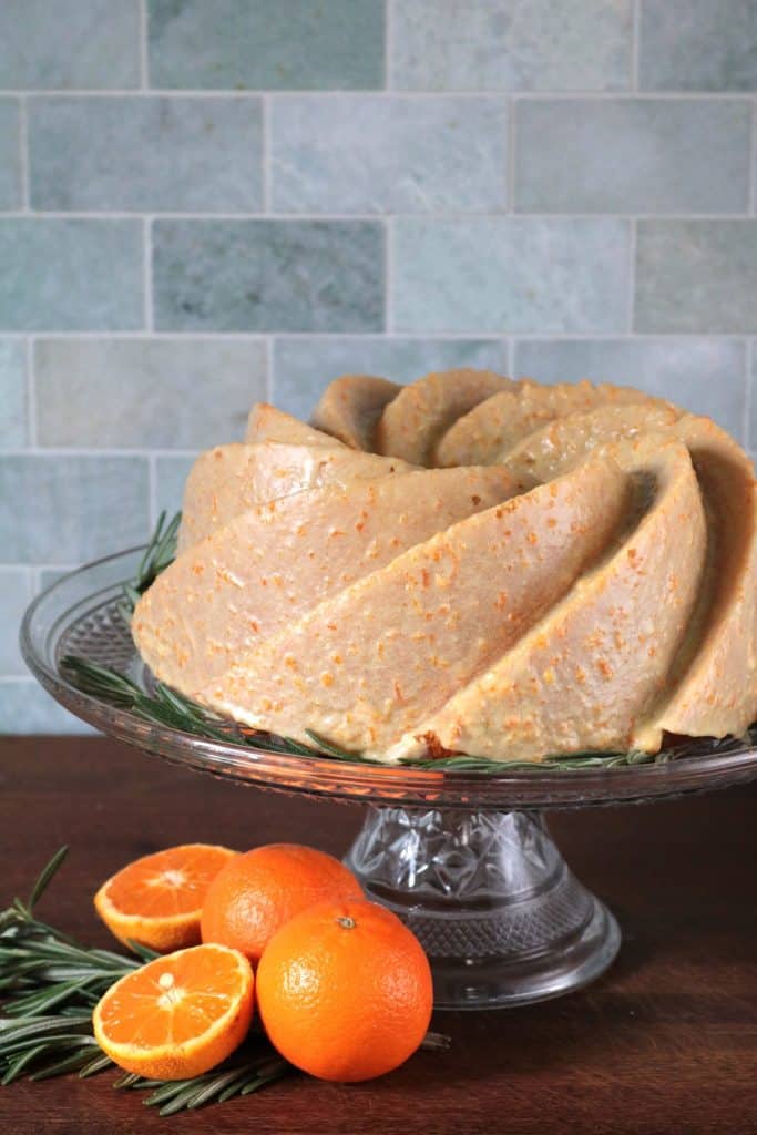 Tangerine Rosemary Olive Oil Cake on a stand.