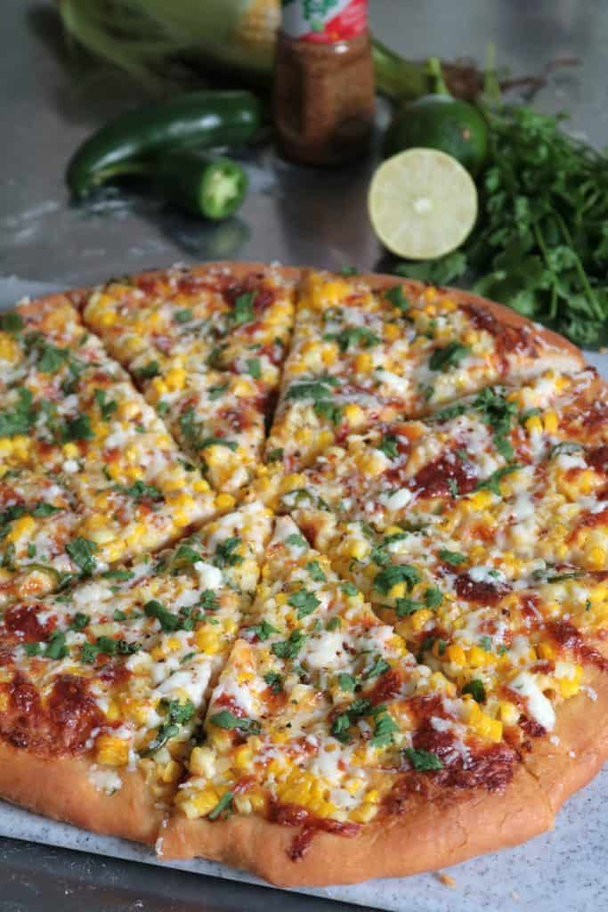 Mexican Street Corn Pizza topped with Tajin and Cilantro.